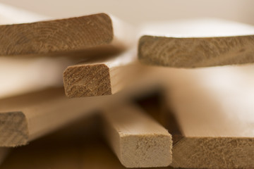 Wooden boards lie on top of each other in a pile