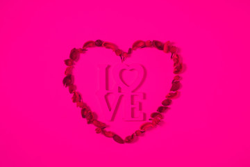 top view of heart from dried fruits with word love isolated on pink