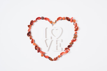 top view of heart from dried fruits with word love isolated on white