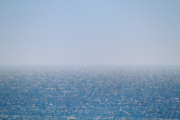 Fototapeta na wymiar Calm sea and blue clear sky. Bright sky and water. Abstract composition