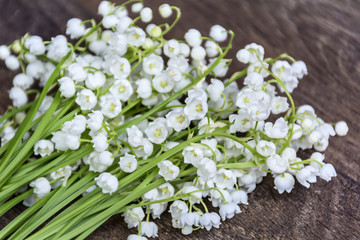 Lily of the valley flowers on a  wooden background