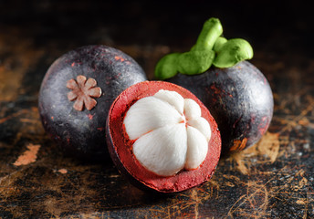 Closeup view of ripe mangosteen on wooden table