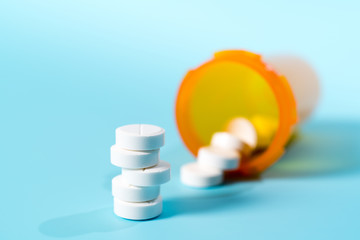 white pills in a yellow plastic bottle