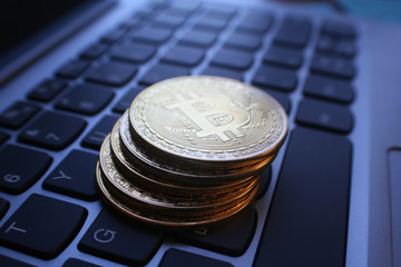 Gold Bitcoins Stacked On Laptop Keyboard Close Up
