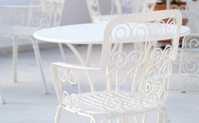 Openwork white . metal chair in the cafe