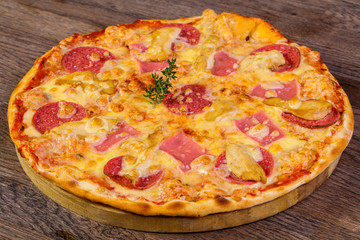 Pizza with ham and sausages