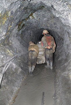 Miners in a dark quarry in Potosi, Bolivia