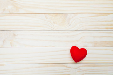 Red heart on wooden table for valentine day concept.