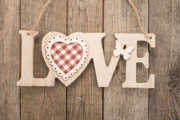 Love sign on wooden background 
