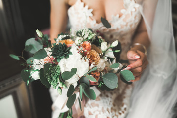 Bride holding big and beautiful wedding bouquet with flowers