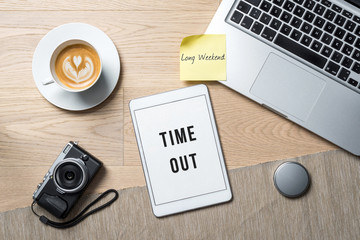 Time out written on tablet in office as flatlay