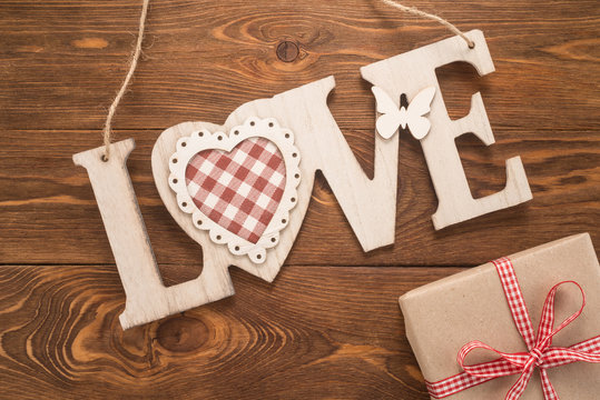   Love sign on wooden background 