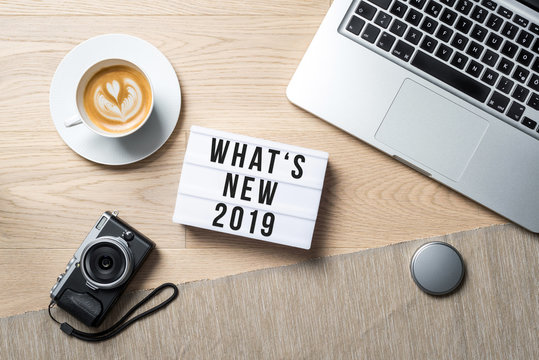 What's new 2019 written on lightbox in office as flatlay
