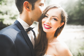Beautiful, perfect happy bride and groom posing on their wedding day. Close up portrait