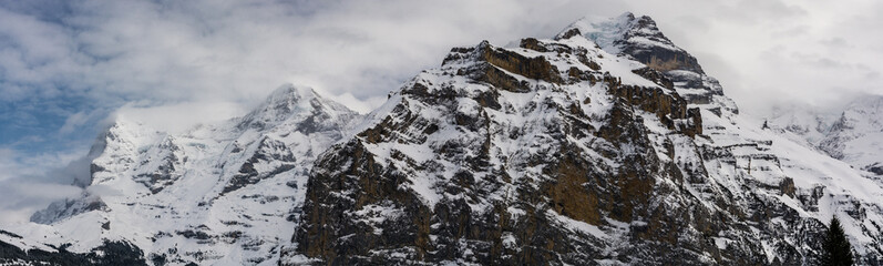 Fototapeta na wymiar Three most famous summits of Bernese Alps in Switzerland covered by snow