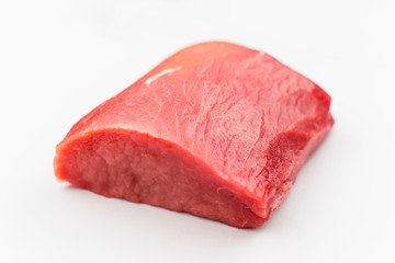 A piece of raw pork on a white background.