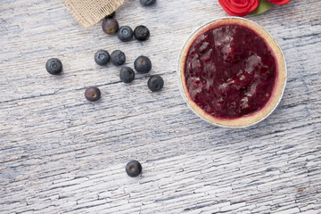 One fruit tart with blueberries on a wooden background with copy space 