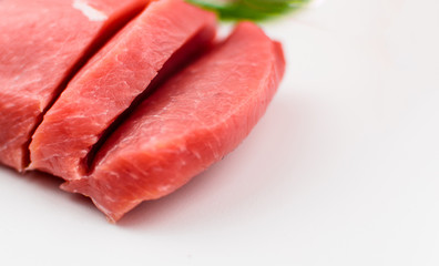 Pork fillet chopped on a white background.