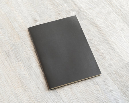 Blank A4 size book, catalog, magazine, brochure, or booklet mock up template paper texture on brown wood table floor