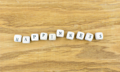 Happiness is the word from wooden cubes.