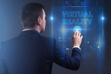 Business, Technology, Internet and network concept. Young businessman working on a virtual screen of the future and sees the inscription: Virtual reality