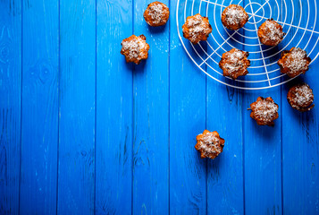 Muffins. Baking with coconut shavings on a blue background.Copy space for Text.selective focus.