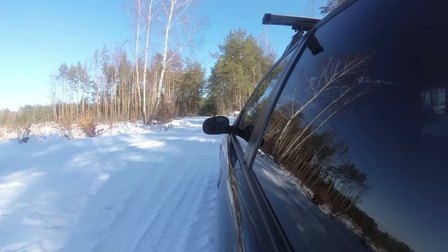 4K.Winter car trip in forest or  park, reflection of trees in  window. POV clip