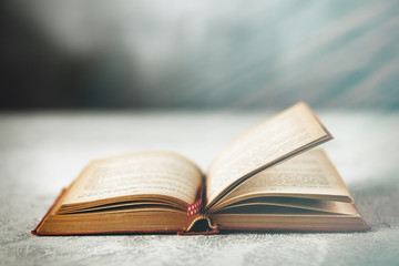 Open book on grey table