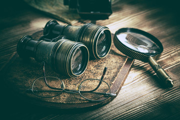 Old objects with lenses: binoculars, camera, magnifying glass and glasses. Vintage style.