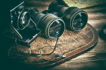 Old objects with lenses: binoculars, camera, magnifying glass and glasses. Vintage style.