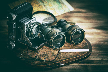 Old objects with lenses: binoculars, camera, magnifying glass and glasses. Vintage style.