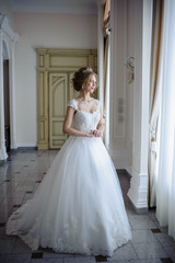 Beautiful bride in wedding dress before wedding ceremony in great hall