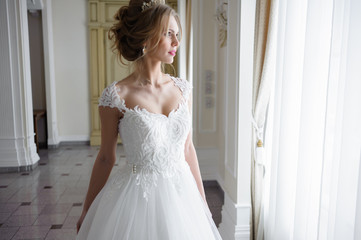 Fototapeta premium Beautiful bride in wedding dress before wedding ceremony