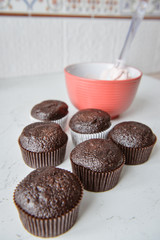 Tasty cupcakes on background table. Homemade chocolate muffin cupcake with cream buttercream icing. Birthday cupcake. Valentine cupcake sweets. Close up view delicious sweet dessert