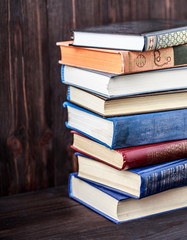 Old books on wooden background. The source of information. Books indoor. Home library. Knowledge is power