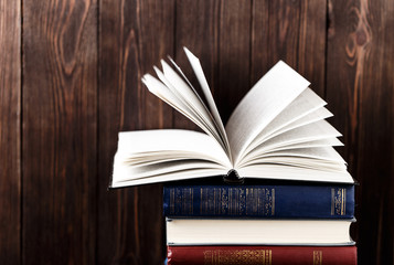 Old books on wooden background. The source of information. Books indoor. Home library. Knowledge is power