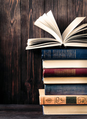 Old books on wooden background. The source of information. Books indoor. Home library. Knowledge is power