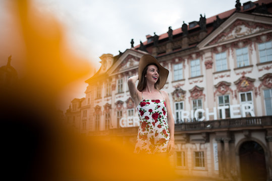 Woman standing in a flower dress at old town square in prague, czech replic