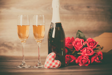 Champagne and red roses