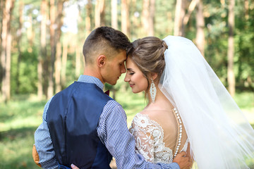 the first kiss of beautiful wedding bride and groom after the wedding ceremony. The wedding day is the day of creating a new family