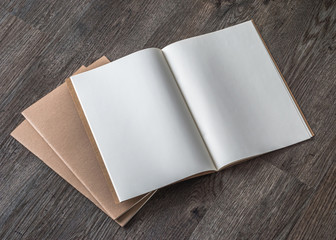 Obraz premium Blank A4-size open book mock up, catalog, magazines, brochure, note template with paper texture on dark color wood table