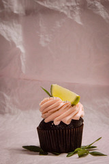Tasty cupcakes on background table. Homemade chocolate muffin cupcake with cream buttercream icing....