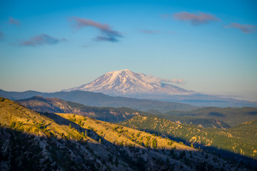 The breathtaking views of the volcano at sunset. The last rays of the sun illuminate a large crater. Mount Adams, view from Windy Ridge Trail