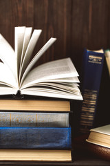 Old books on wooden background. The source of information. Books indoor. Home library. Knowledge is power