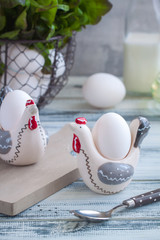 Eggs in handmade hens trays over the wooden background. Easter postcared concept.