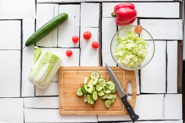 Vegetables lie on a table on a chopping board