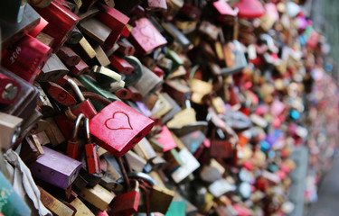 Valentine's Day - many padlocks on a bridge - red padlock with heart in the front