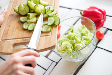 Vegetables lie on a table on a chopping board