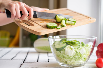 Vegetables lie on a table on a chopping board