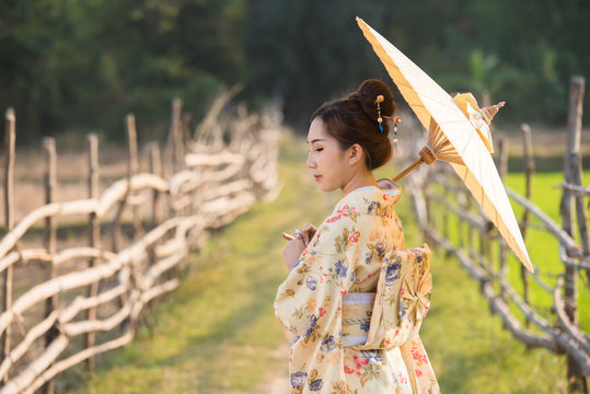Japanese women wear kimono holding umbrellas 